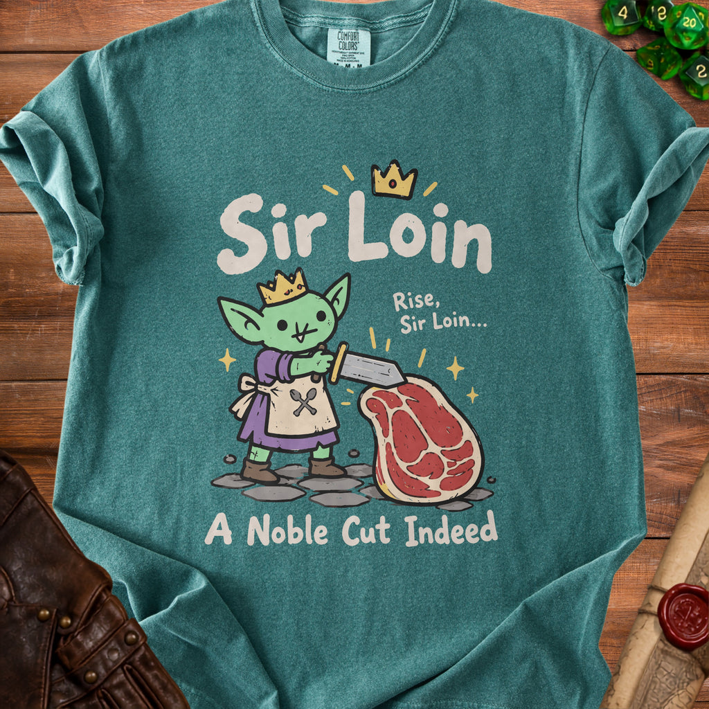 Green t-shirt with a cartoon goblin holding a sword over a steak, text reads "Sir Loin" and "A Noble Cut Indeed".