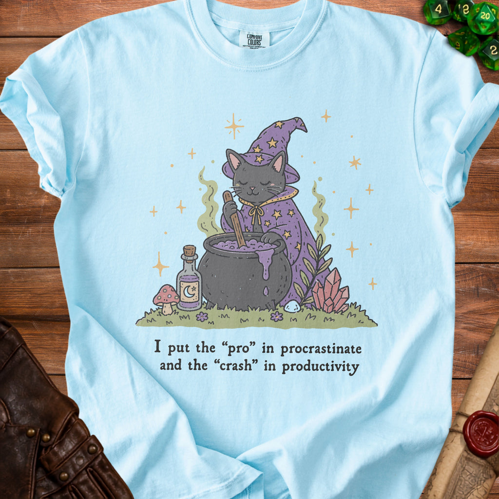 T-shirt with a black cat wizard stirring a cauldron and the text "I put the 'pro' in procrastinate".