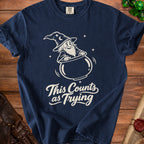 Navy t-shirt with a cartoon wizard stirring a pot with "This Counts as Trying" text.
