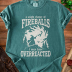 Teal t-shirt with white text and graphic of a wizard casting fireballs.