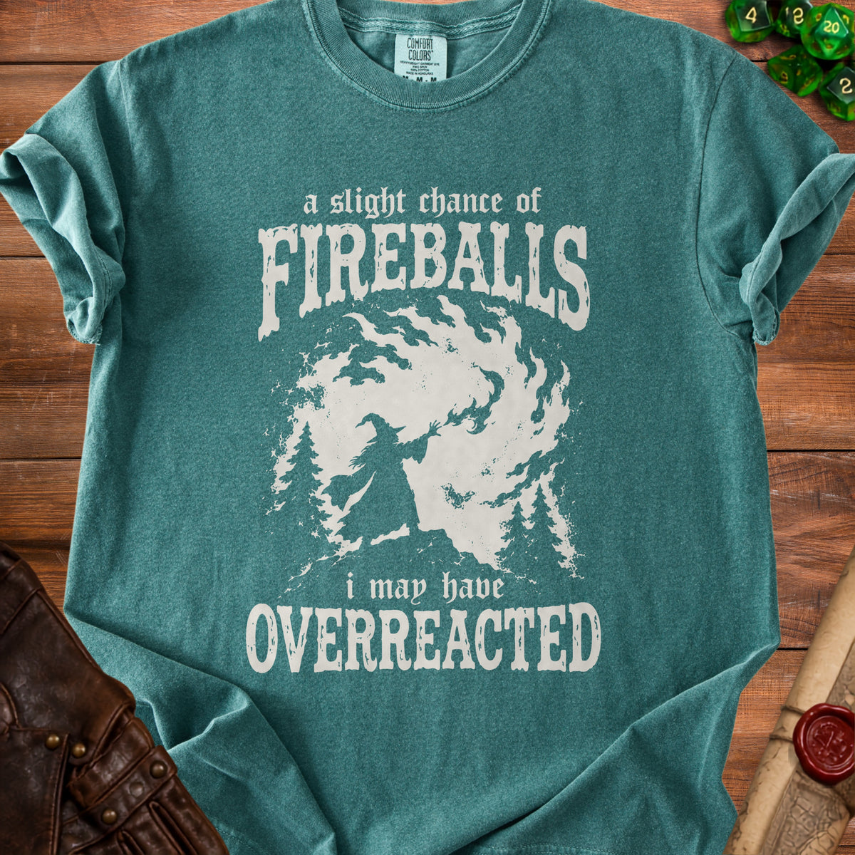Teal t-shirt with white text and graphic of a wizard casting fireballs.
