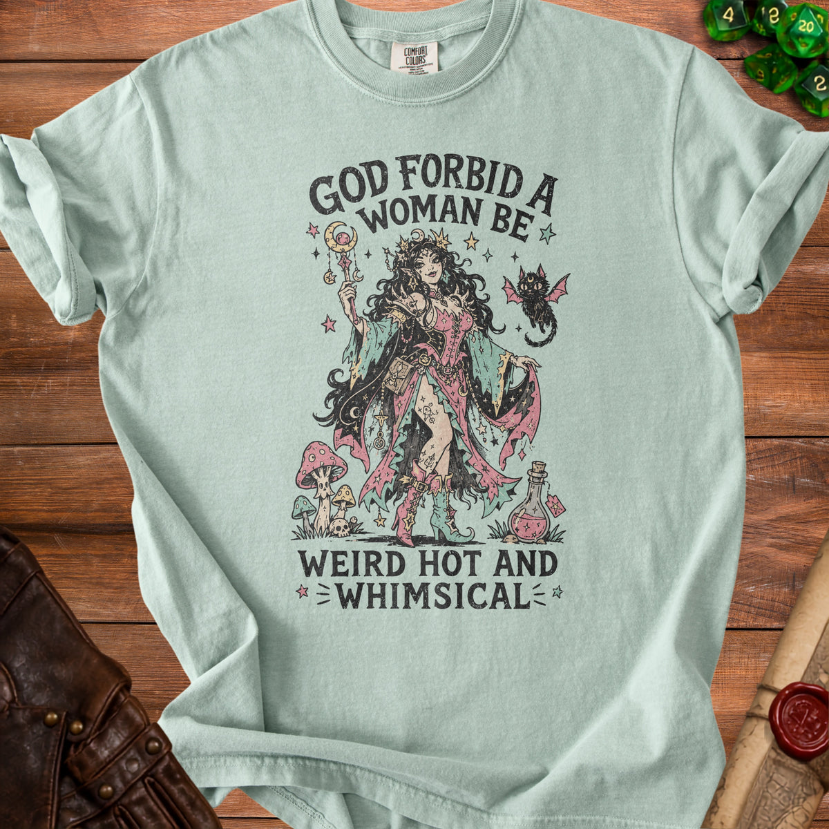 Light blue t-shirt with "God forbid a woman be weird hot and whimsical" text and gothic illustration.