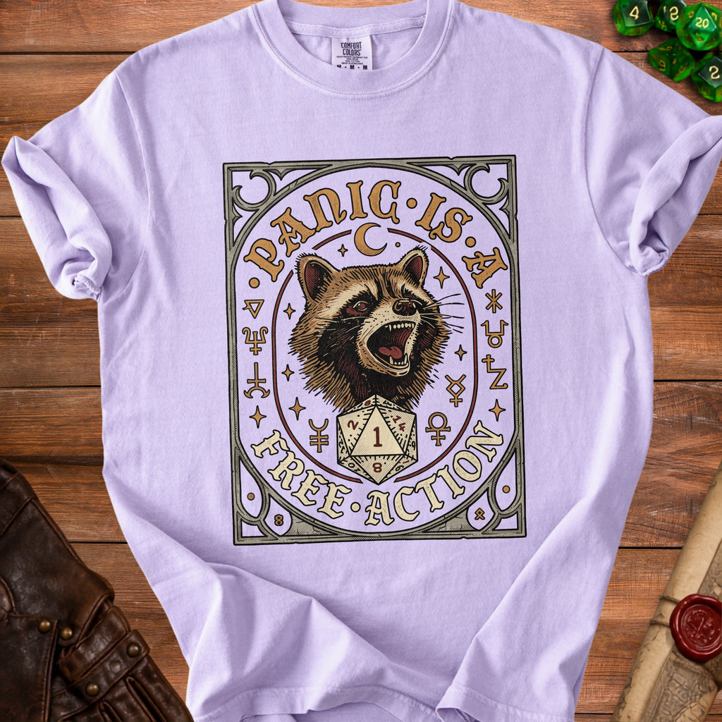 Purple t-shirt with a raccoon and dice graphic that reads "Panic is a Free Action".