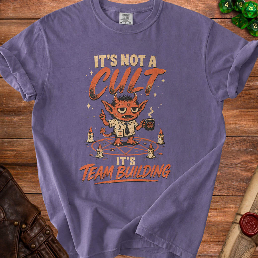 Purple t-shirt with graphic saying "It's Not A Cult It's Team Building" and a devil character.