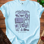 Light blue t-shirt with "Minor curse kit" design featuring occult items and text.