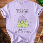 Lavender t-shirt with "Not Lazy Just On Energy Saving Mode" and sleepy creature graphic.