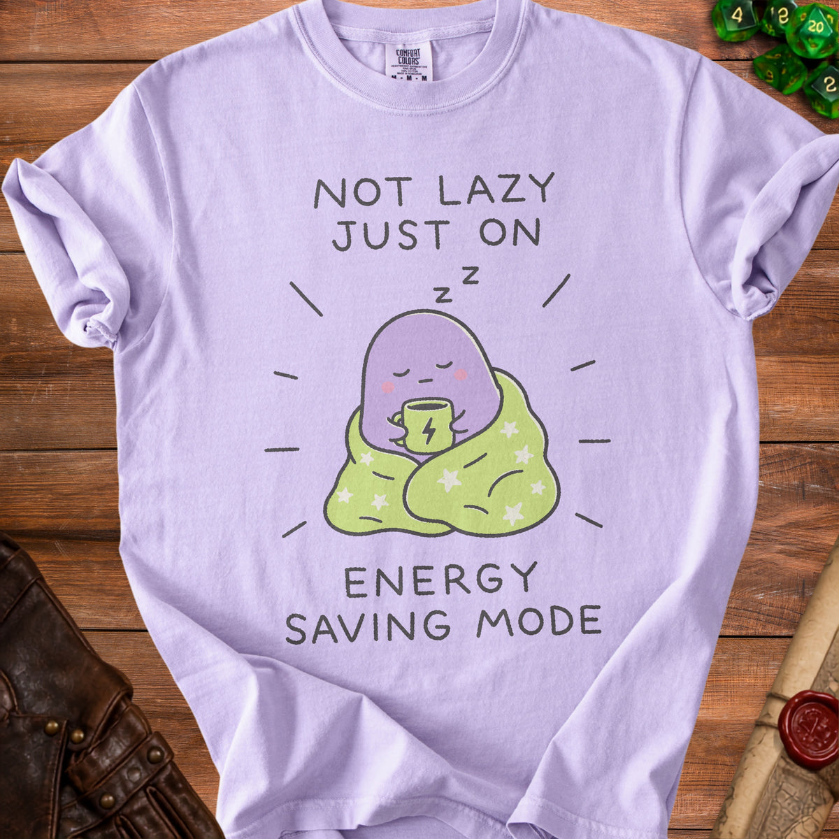 Lavender t-shirt with "Not Lazy Just On Energy Saving Mode" and sleepy creature graphic.