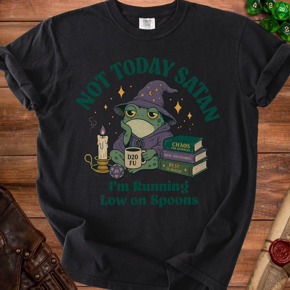T-shirt with a frog wizard, D20 mug, dice, and books. Text reads "Not Today Satan, I'm Running Low on Spoons."