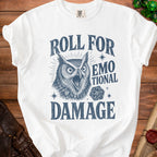 White t-shirt with owl graphic and text "Roll For Emotional Damage" and dice.