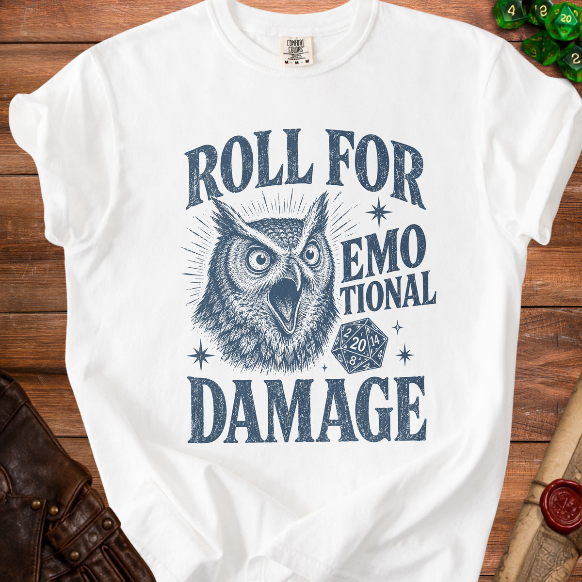 White t-shirt with owl graphic and text "Roll For Emotional Damage" and dice.