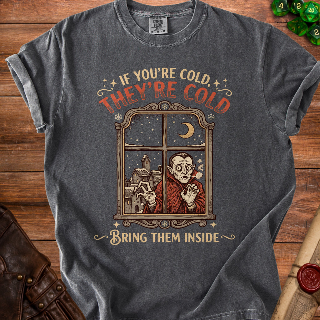 Dark grey t-shirt with a vampire looking through a snowy window, reading "If you're cold, they're cold. Bring them inside."