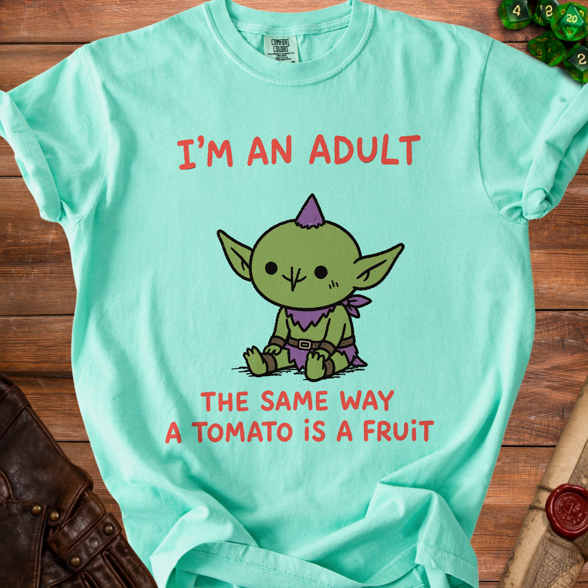 Aquamarine t-shirt with red text and a cartoon goblin saying "I'm an adult".