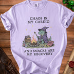 Purple t-shirt with a graphic of a dragon roasting marshmallows and text "Chaos is my cardio and snacks are my recovery."