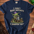 Goblin sharpening an axe on a grindstone with text "I don't bury hatchets, I sharpen them".