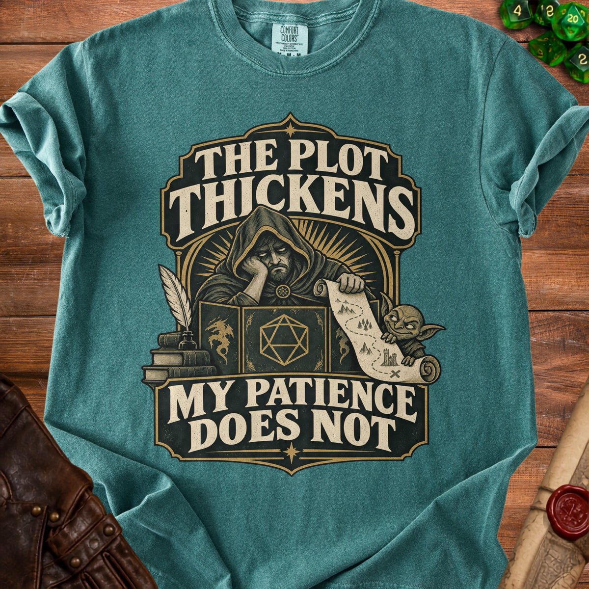 Shirt with design featuring a weary wizard, books, dice, and text "The plot thickens. My patience does not."