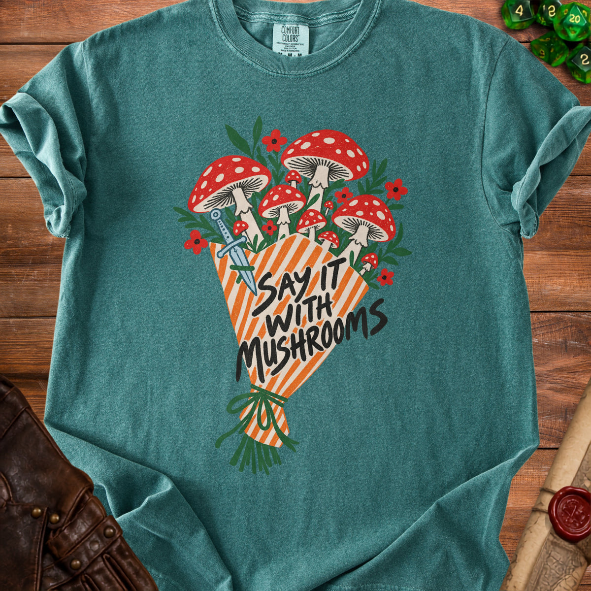 Teal t-shirt with a bouquet of red and white mushrooms and the text "Say It With Mushrooms".