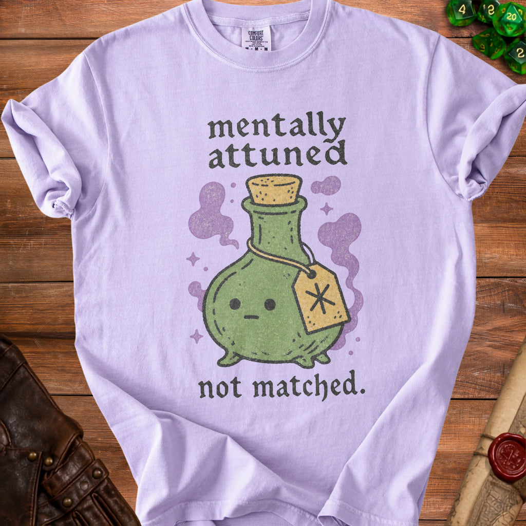 Light purple t-shirt with a potion bottle graphic and the text "mentally attuned not matched."