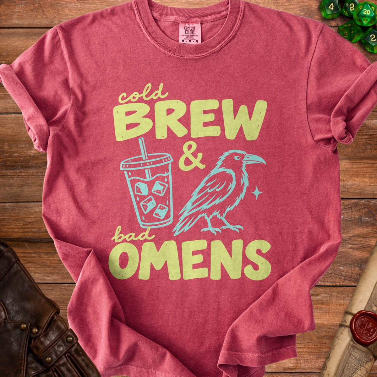 Crimson t-shirt with "Cold Brew & Bad Omens" text, iced coffee cup, and raven graphic.