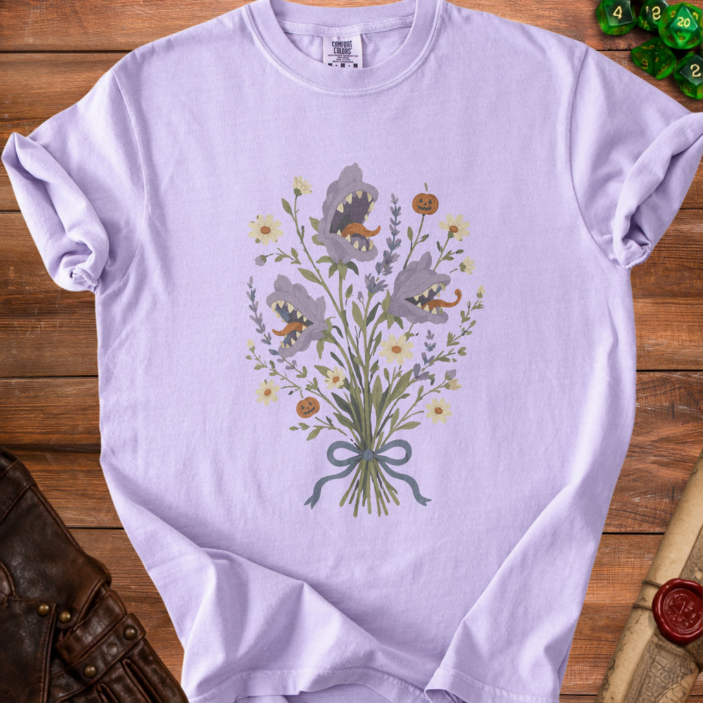 Purple t-shirt with bouquet of spooky flowers and pumpkins graphic.