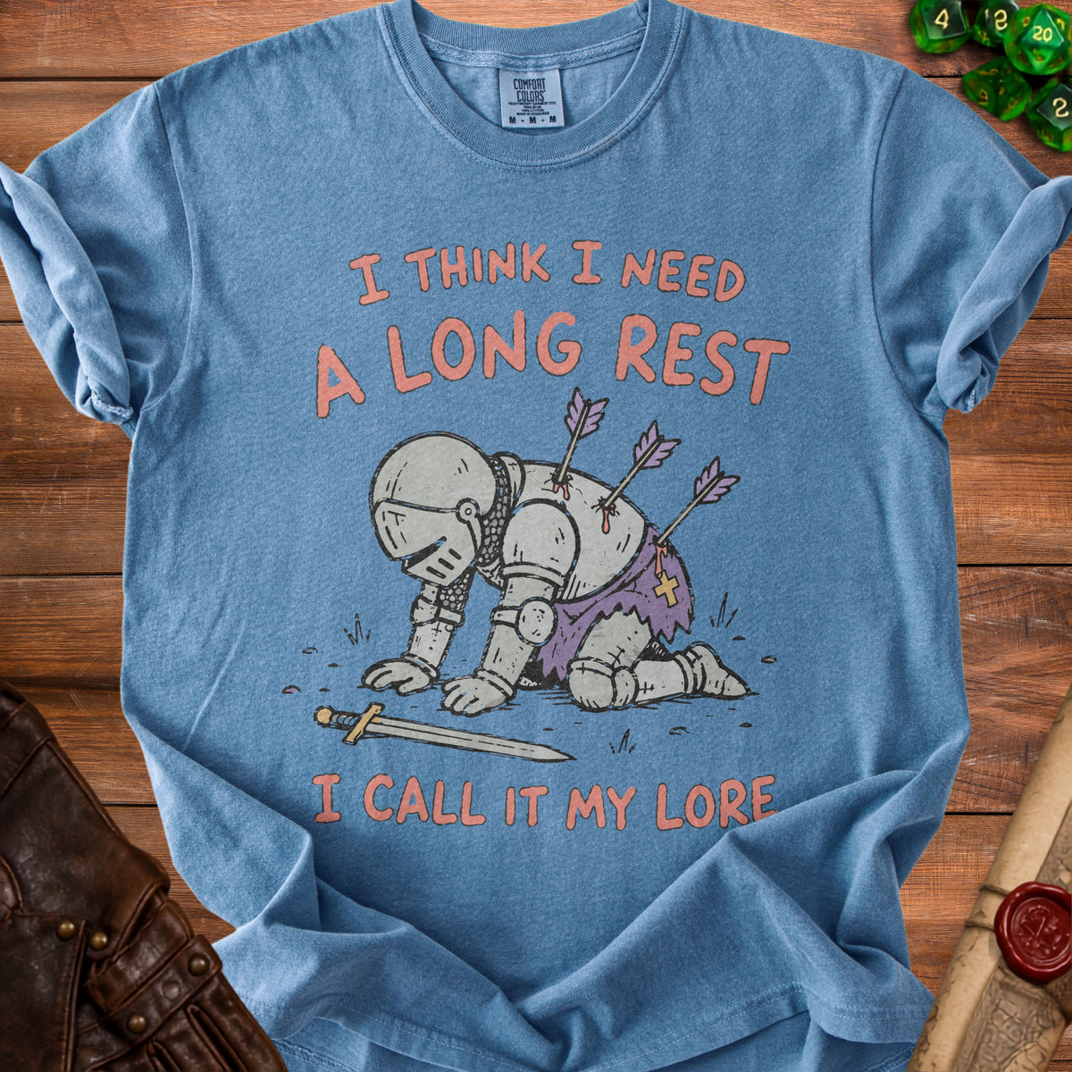 Blue t-shirt with a knight on his knees with arrows in his back.