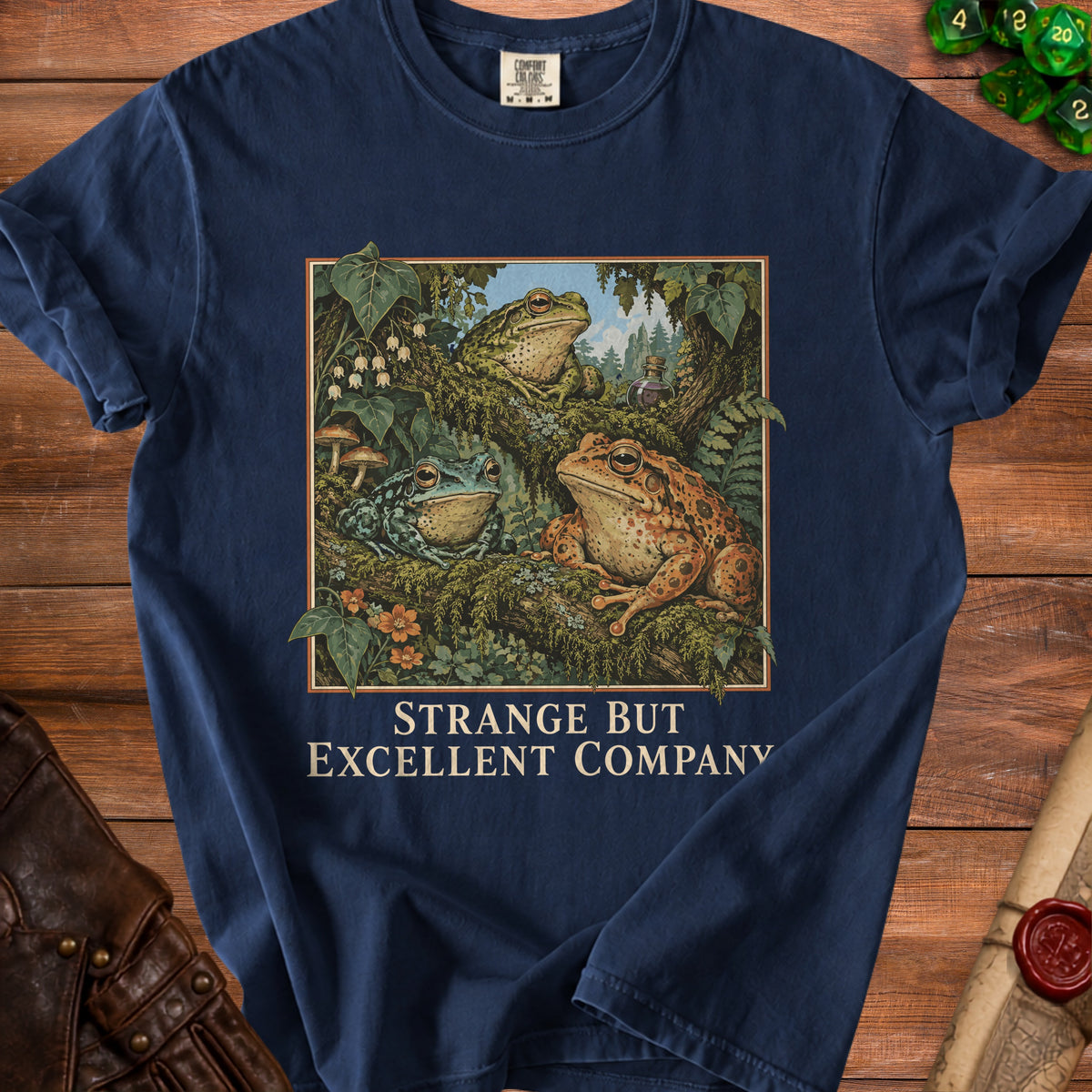 Navy t-shirt with three frogs and text "Strange But Excellent Company".