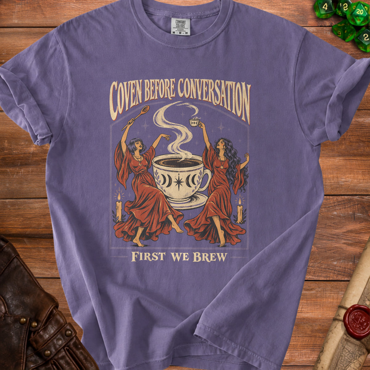 Purple t-shirt with "Coven Before Conversation First We Brew" text and graphic.