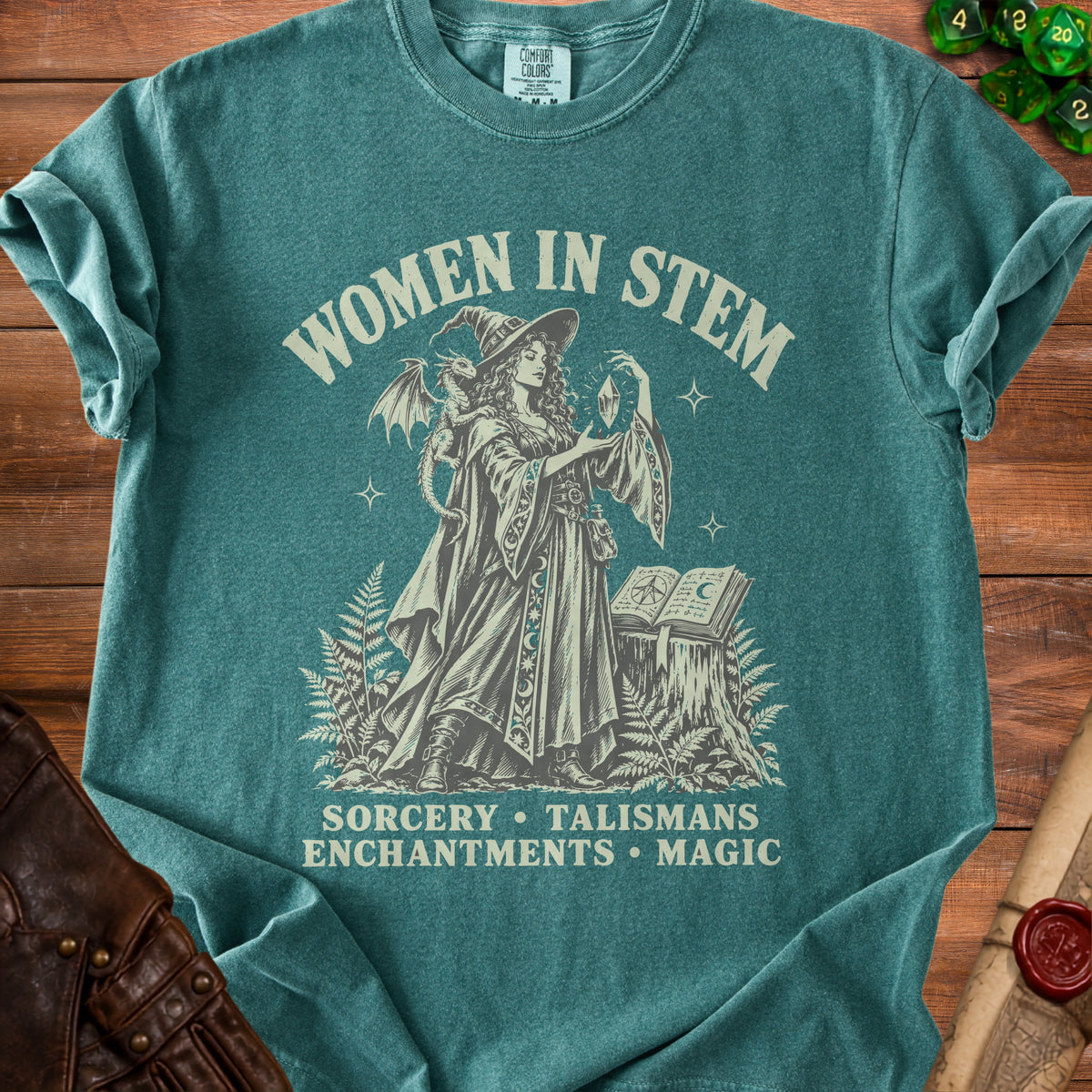 Women in STEM graphic t-shirt with witch, dragon, and spellbook design.