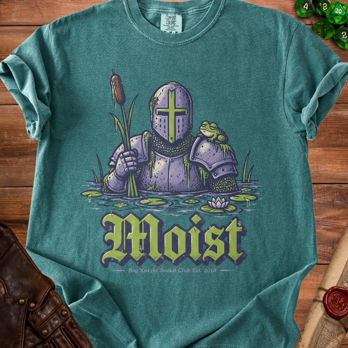 Knight in armor with frog, holding cattail, with "Moist" text and Bog Knight Est. 2018.
