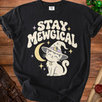 Black t-shirt with "Stay Mewgical" text and a cat wearing a witch hat.