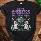 Black t-shirt graphic: "BE THE ANCESTOR THEY SUMMON WHEN SHIT GETS REAL".