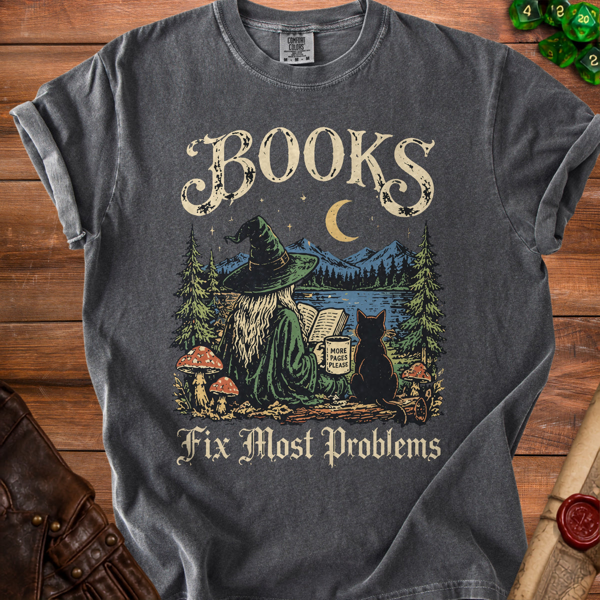 Dark gray t-shirt with a witch reading by moonlight and text: "BOOKS Fix Most Problems."