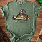 T-shirt with green wizard frog sleeping on a book, text reads "Out of spell slots."