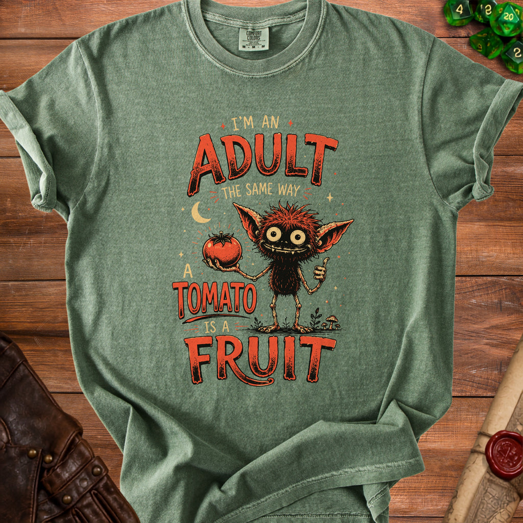 Green t-shirt with a monster holding a tomato and the text "I'm an adult the same way a tomato is a fruit."