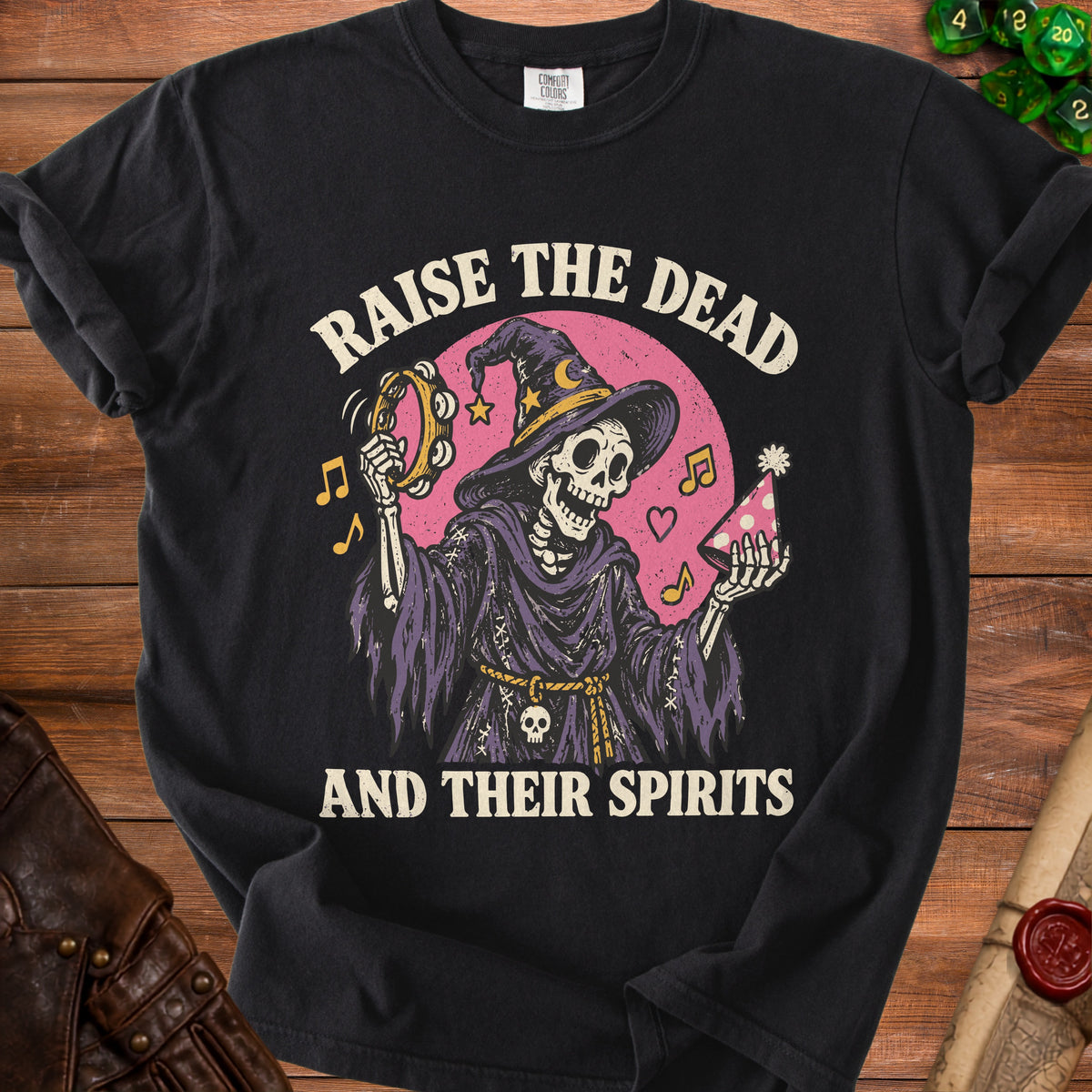 Skeleton wearing a witch hat plays tambourine with text "Raise the Dead and Their Spirits."
