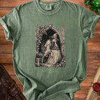 Green t-shirt with gothic art of a witch reading, "LONG REST SHORTLY INTERRUPTED".