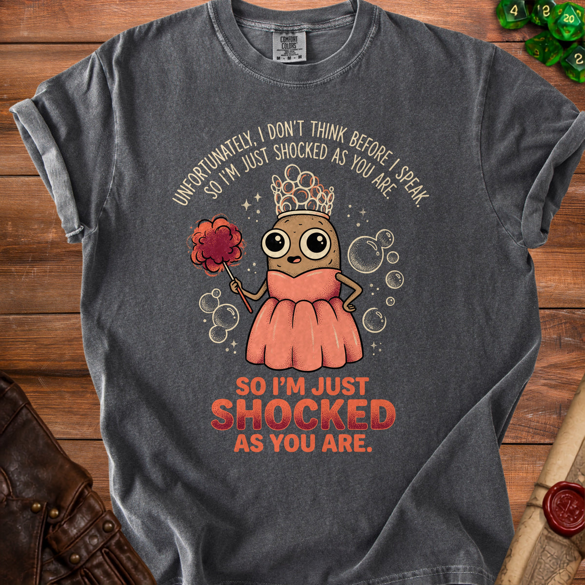 Gray t-shirt with a potato character wearing a crown and dress, holding a duster.