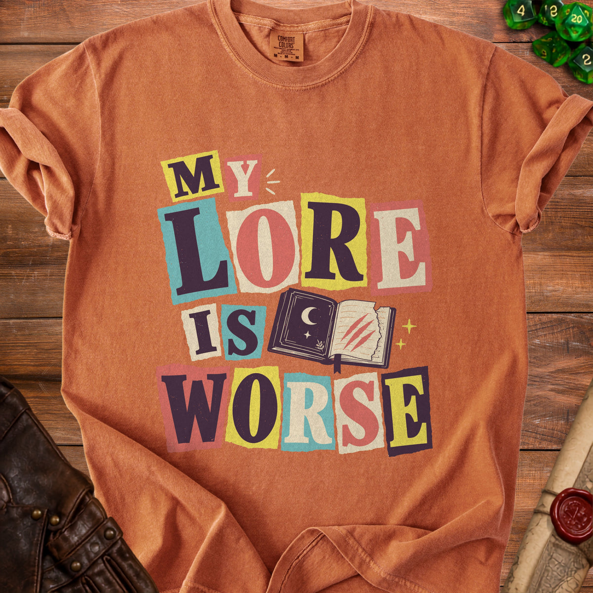 Orange t-shirt with "MY LORE IS WORSE" text and an open book illustration.