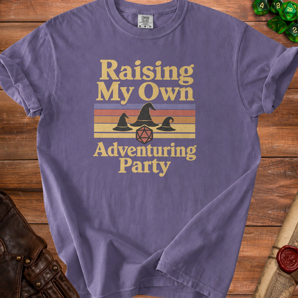 Purple t-shirt with "Raising My Own Adventuring Party" text and wizard hats.