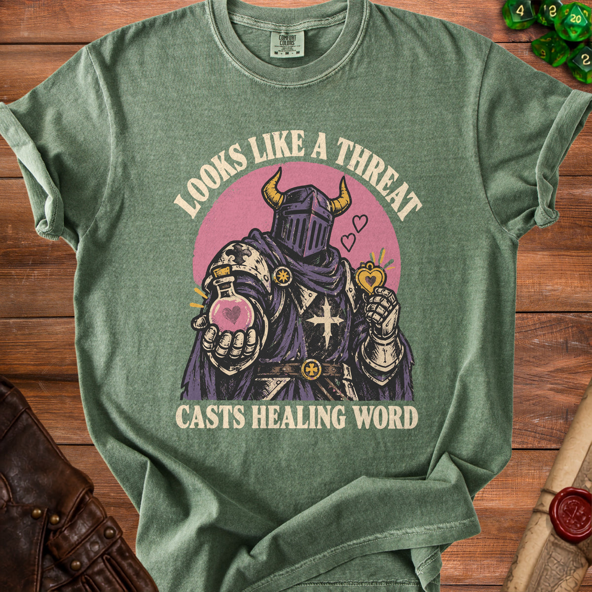 Green t-shirt with knight graphic and text "Looks Like a Threat Casts Healing Word".