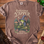 Brown t-shirt with a graphic of a frog in a witch hat holding a mug, saying "Professional Yapper And Other Questionable Skills."