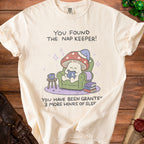Cream t-shirt with graphic: "You Found The Nap Keeper! You Have Been Granted 3 More Hours of Sleep!"