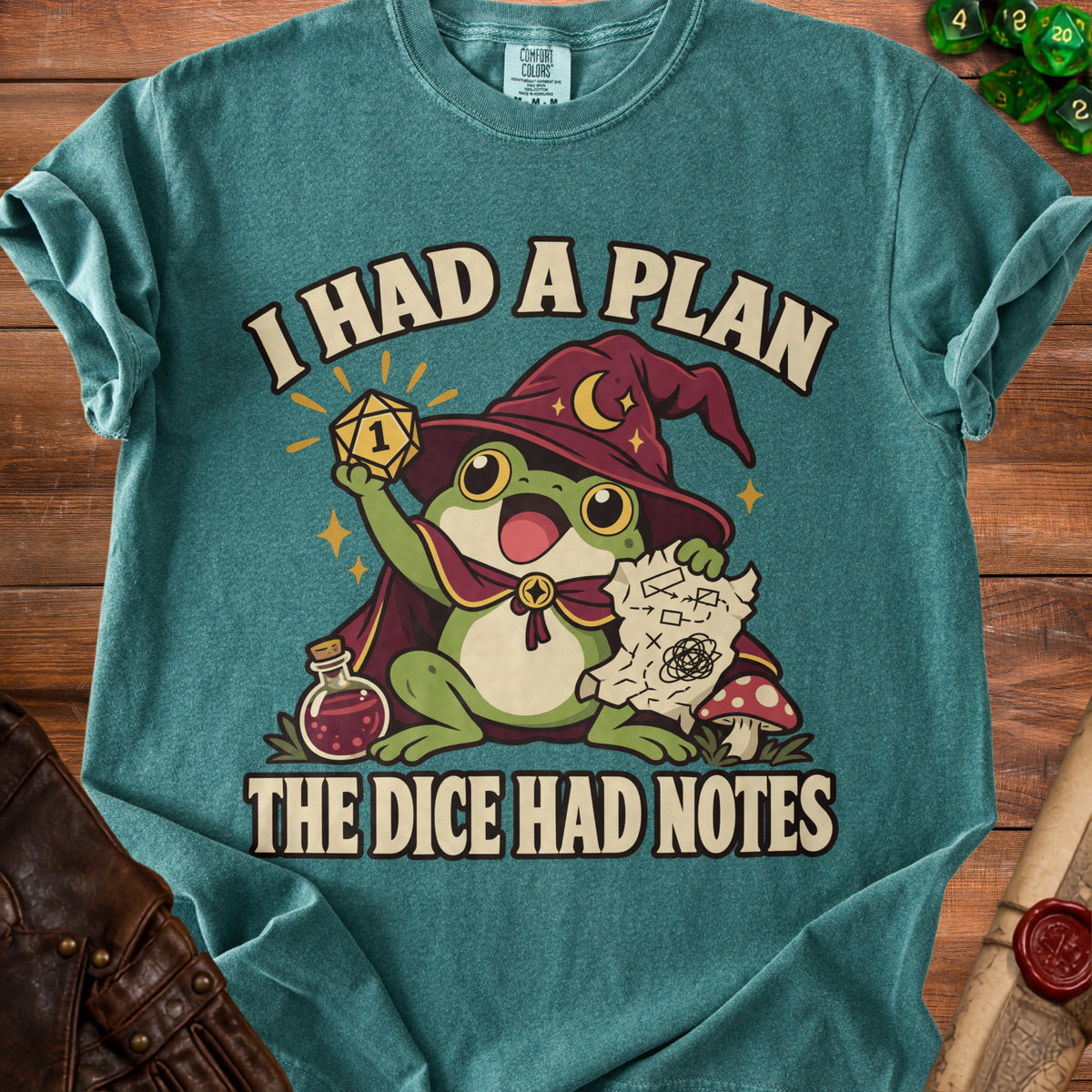 Frog wizard holding a D20 dice, with text "I HAD A PLAN THE DICE HAD NOTES".