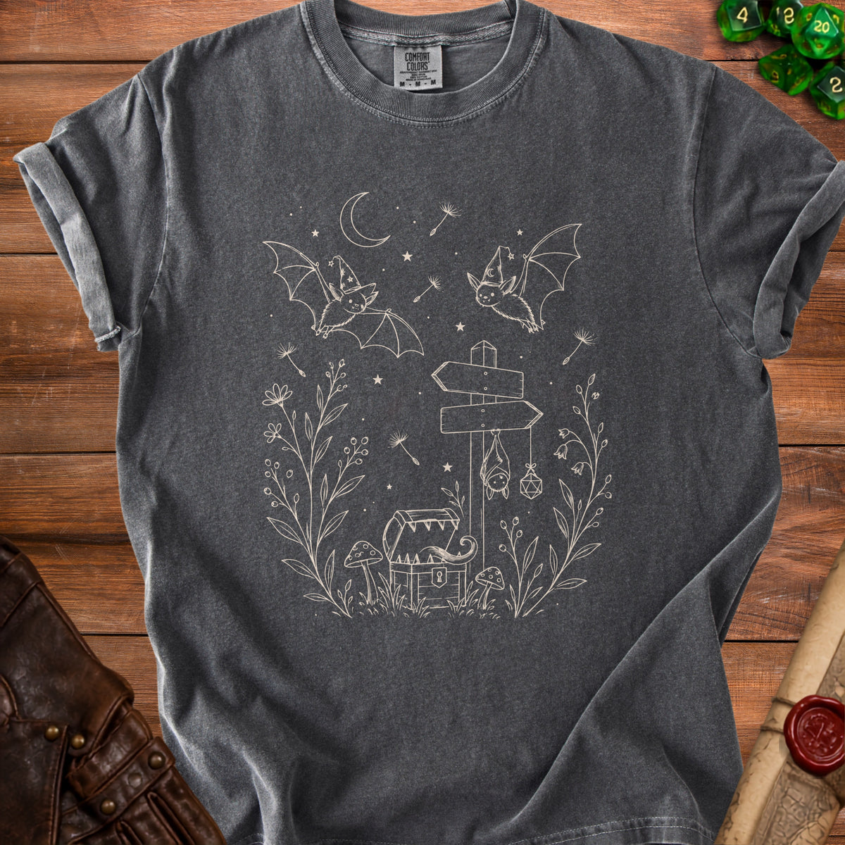 Dark grey t-shirt with white line art of bats, treasure chest, mushrooms, and plants.