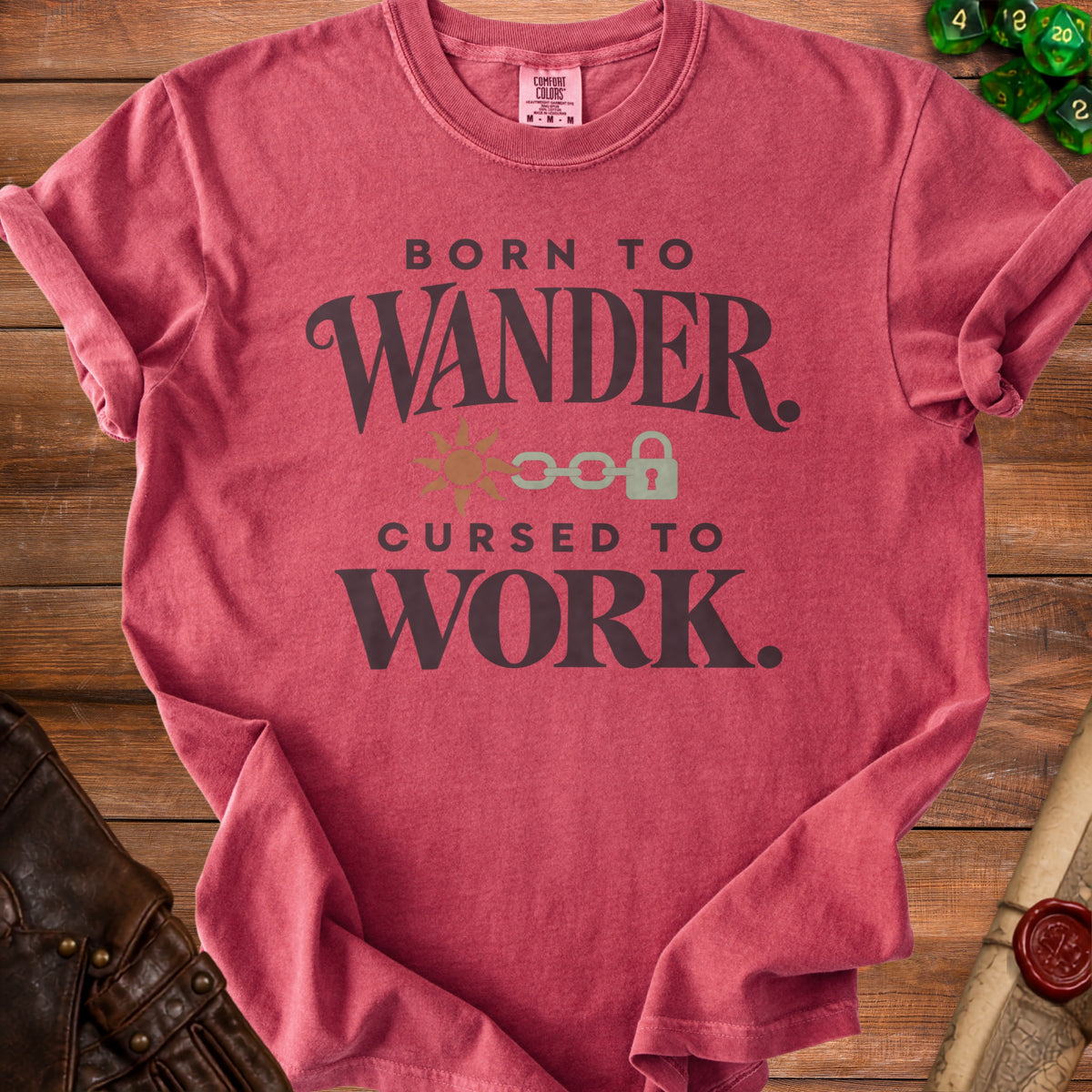 Red Comfort Colors t-shirt with "Born to Wander. Cursed to Work." graphic.