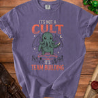 Purple t-shirt with Cthulhu graphic and text "IT'S NOT A CULT IT'S TEAM BUILDING".