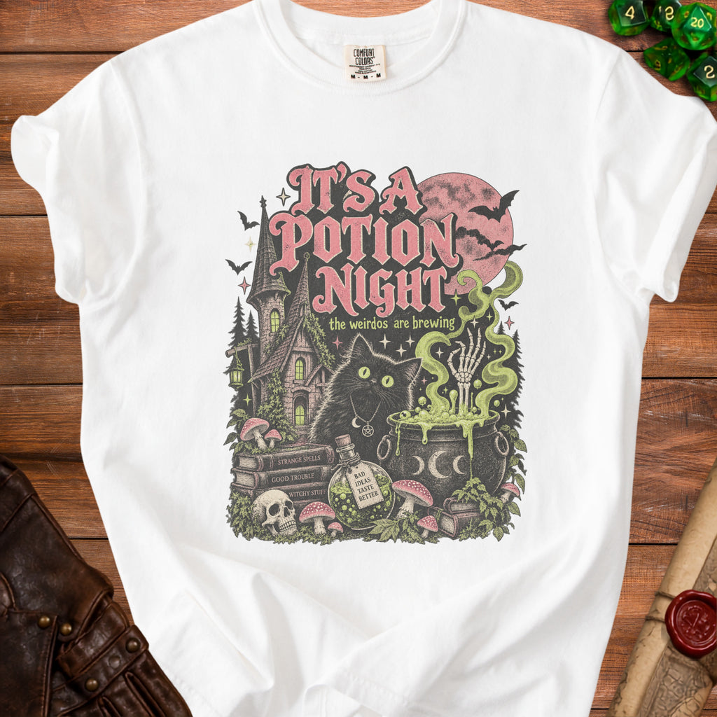 White t-shirt graphic with a black cat, potion, and spooky castle; text reads "It's a Potion Night."