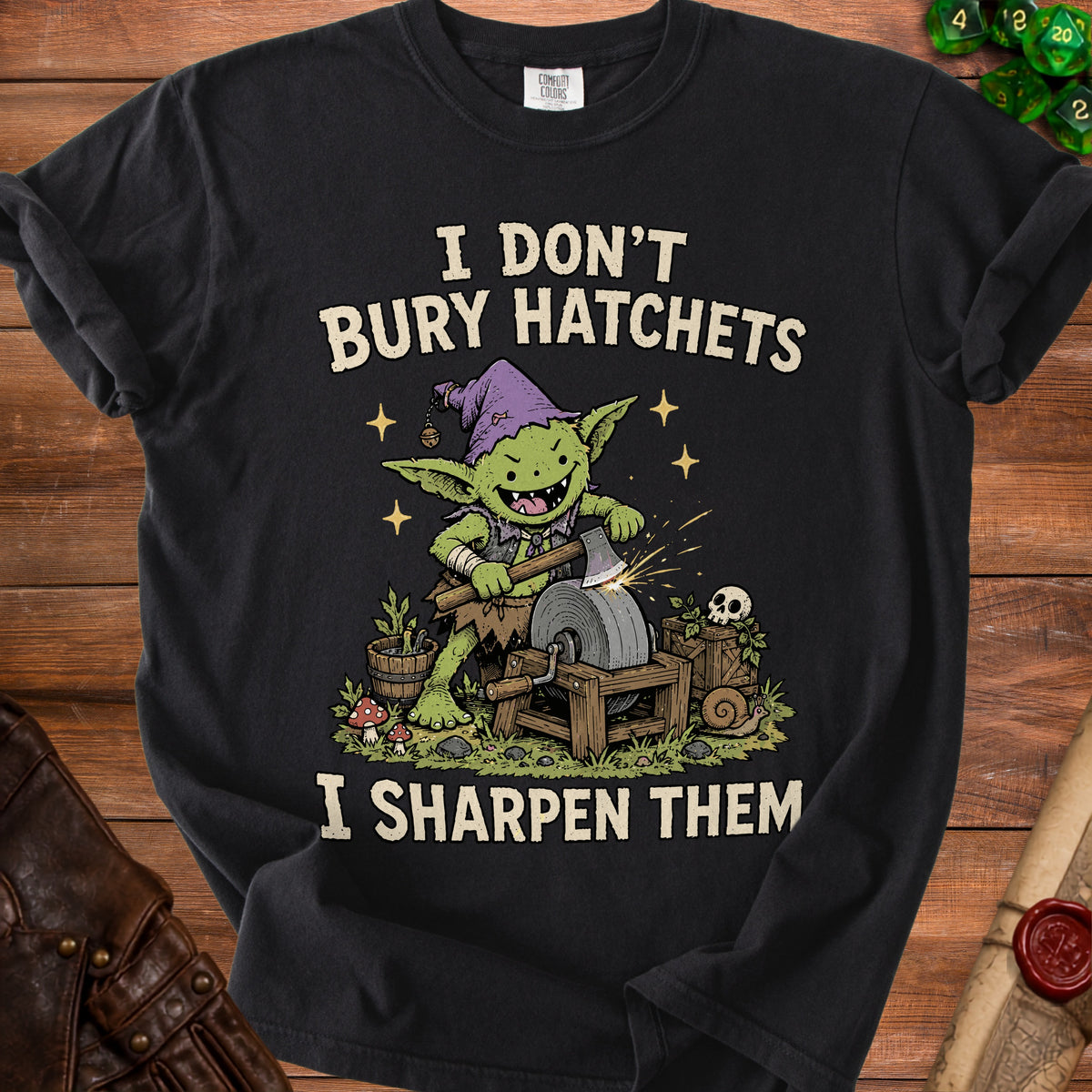Black t-shirt with goblin sharpening an axe and text "I DON'T BURY HATCHETS I SHARPEN THEM".