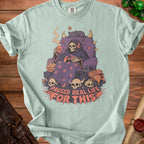 Light blue t-shirt with grim reaper playing video games and text "PAUSED REAL LIFE FOR THIS".