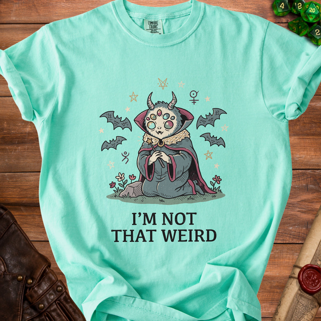 Mint green t-shirt with a creature graphic and text "I'M NOT THAT WEIRD".
