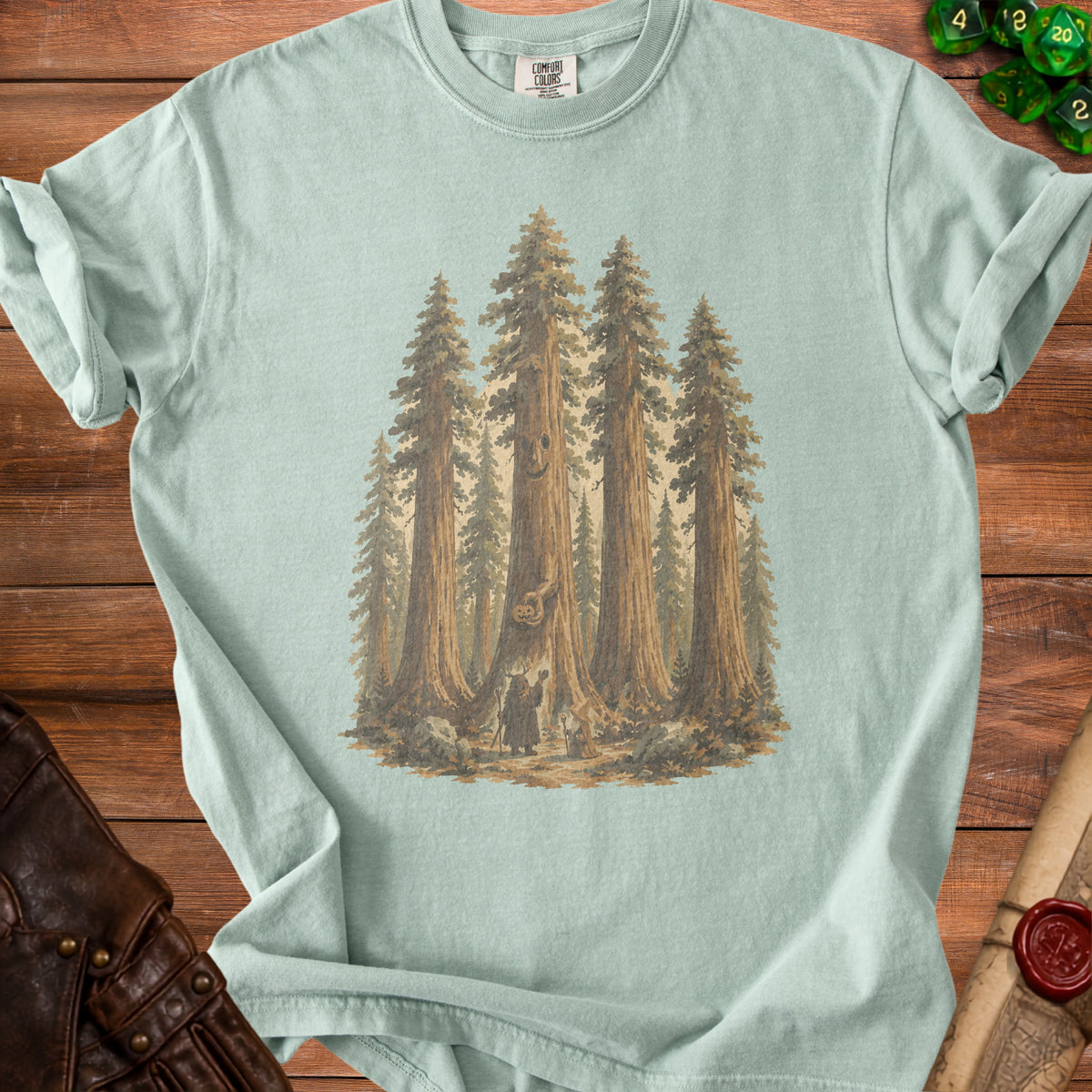 T-shirt with illustration of sequoia trees, a pumpkin, and two figures.